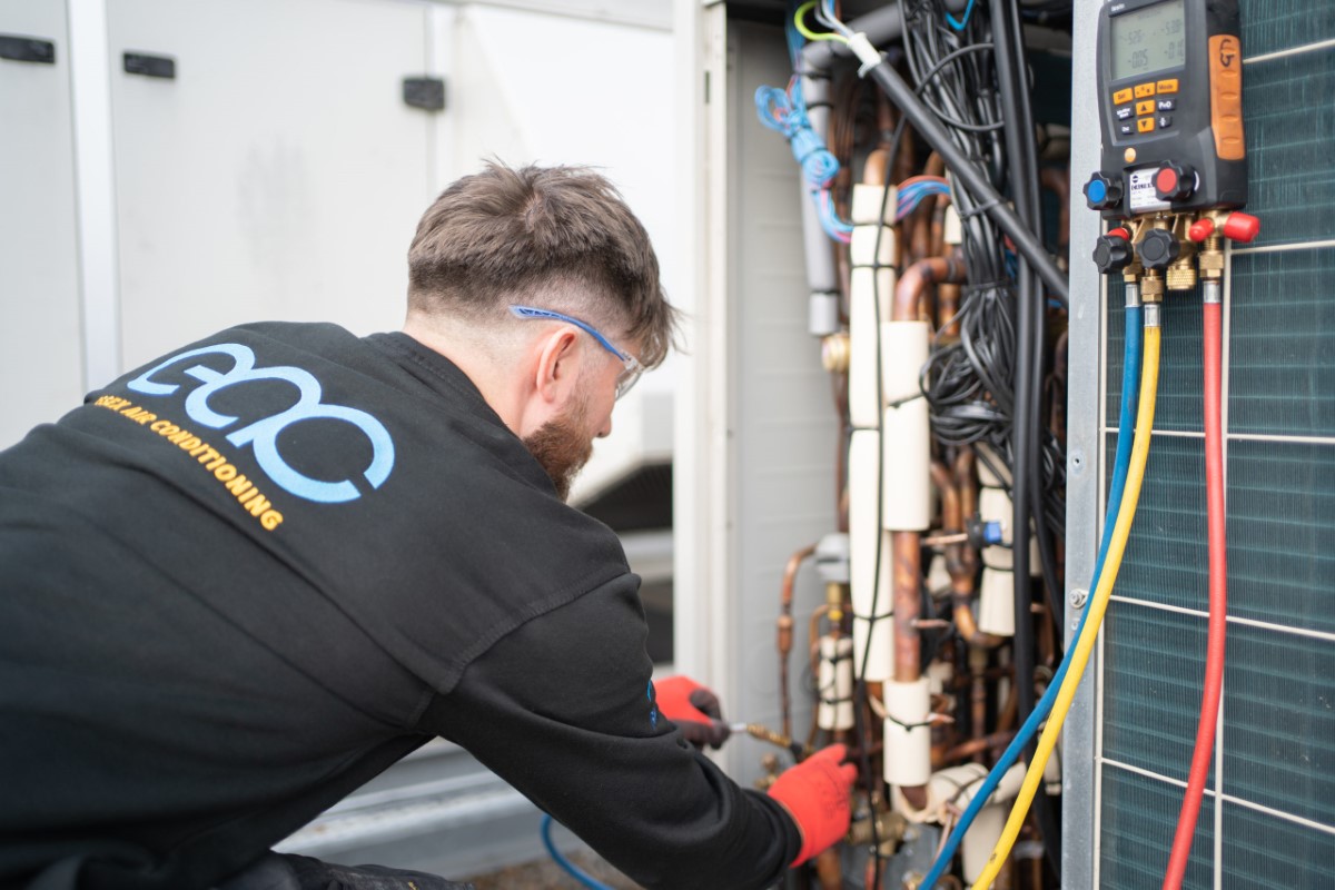 Worker carrying out air conditioning checks